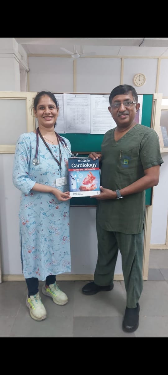 Presenting book to Dr Kiron Varghese, then HOD Cardiology, St Johns Hospital, Bangalore